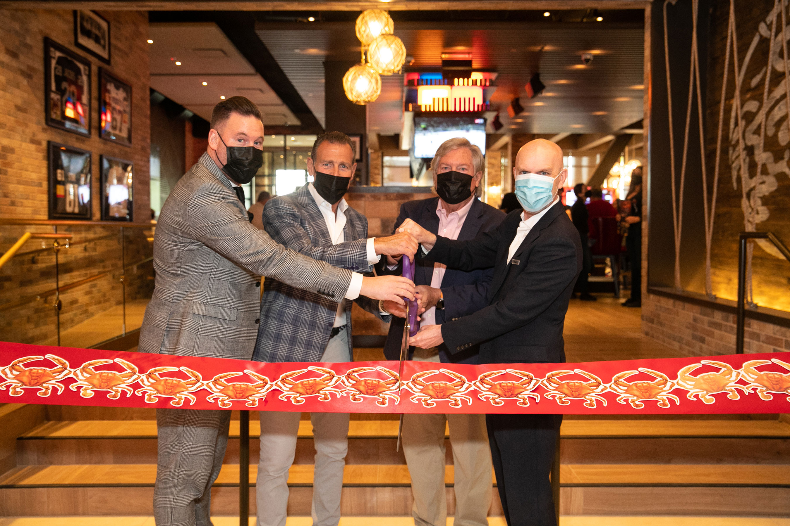 (L-R) Anthony Olheiser, Pete Ciarrocchi, Clark County Commissioner Tick Segerblom, and Paul Hobson cut the ribbon at the grand opening celebration of Chickie’s & Pete’s Crab House and Sports Bar inside SAHARA Las Vegas