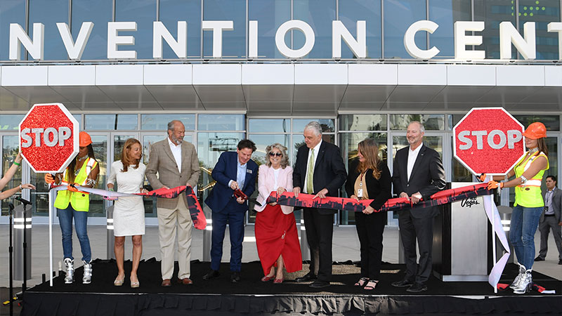 Dignitaries and representatives from the Las Vegas Convention & Visitors Authority and Informa Markets participate in a ribbon cutting ceremony 