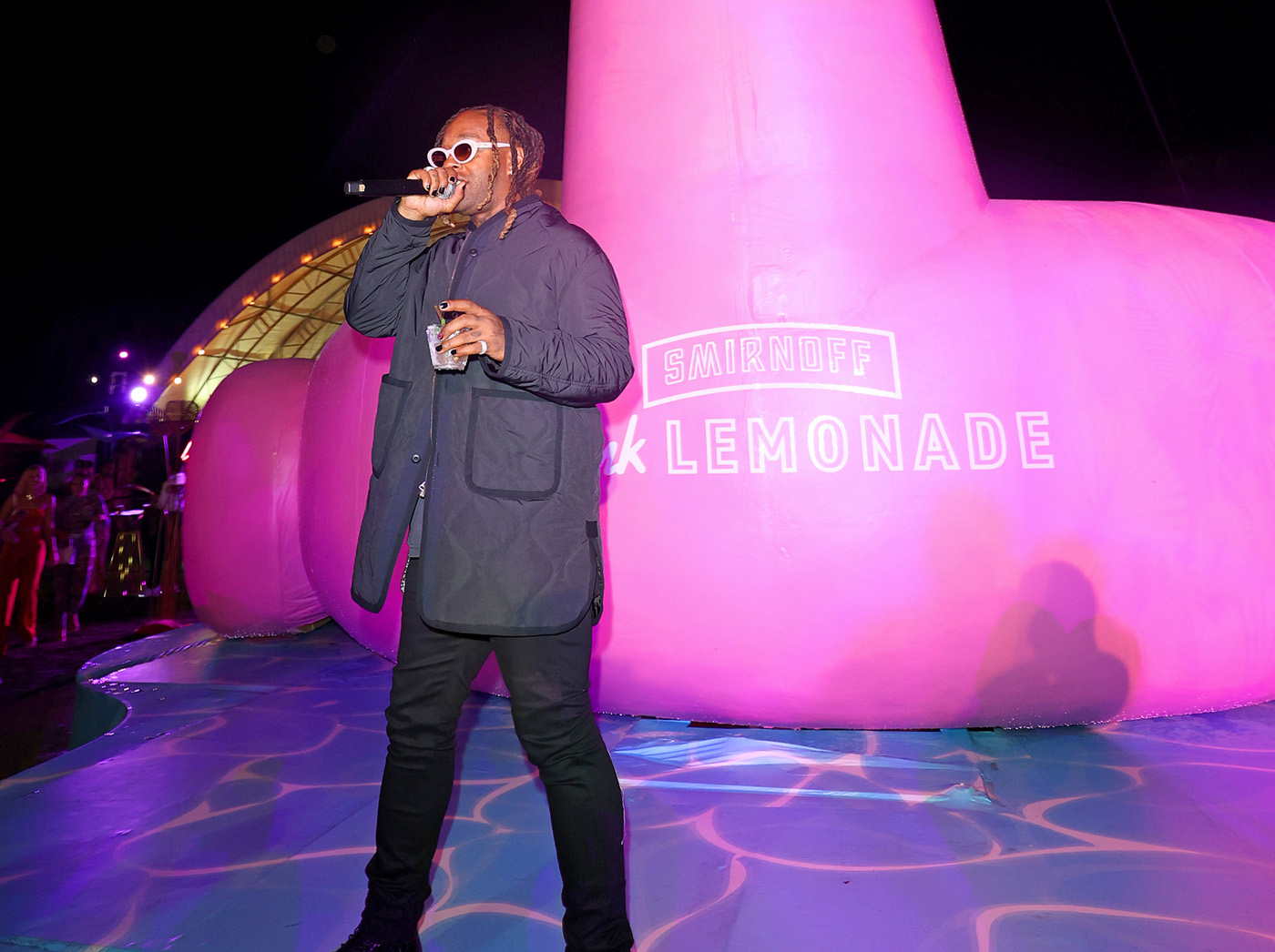 Ty Dolla $ign singing in front of large flamingo.