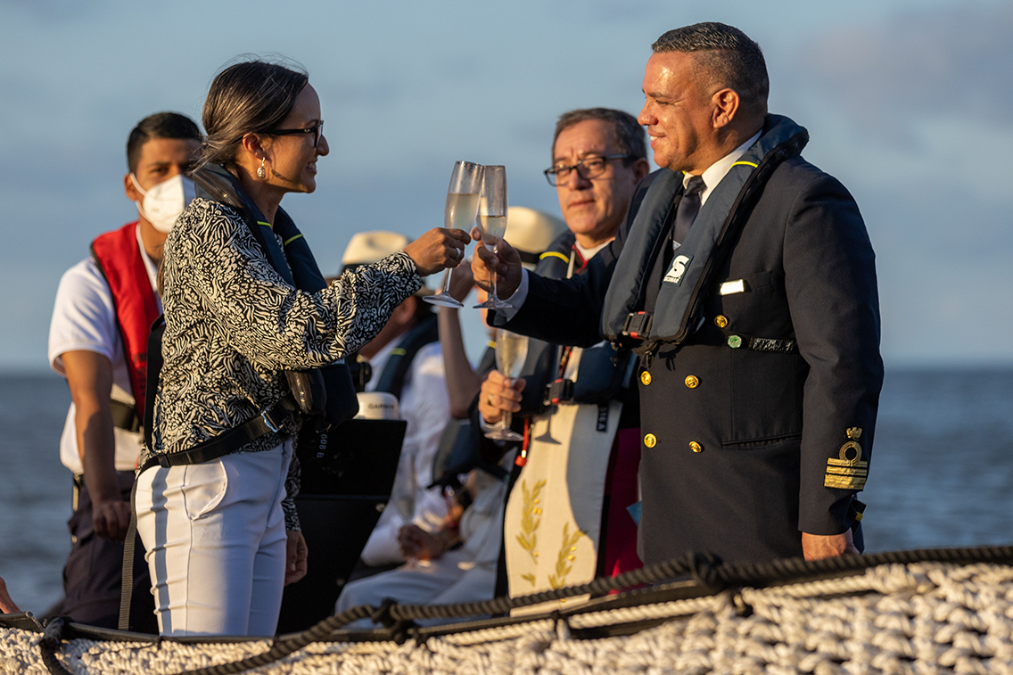 Johanna Carrión raises a glass with Captain Karin Chacon