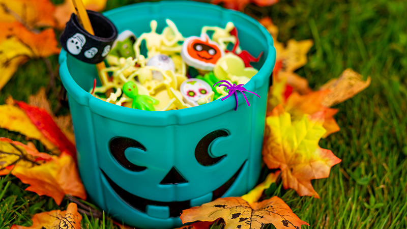 Pumpkin bucket of Halloween-themed trinkets