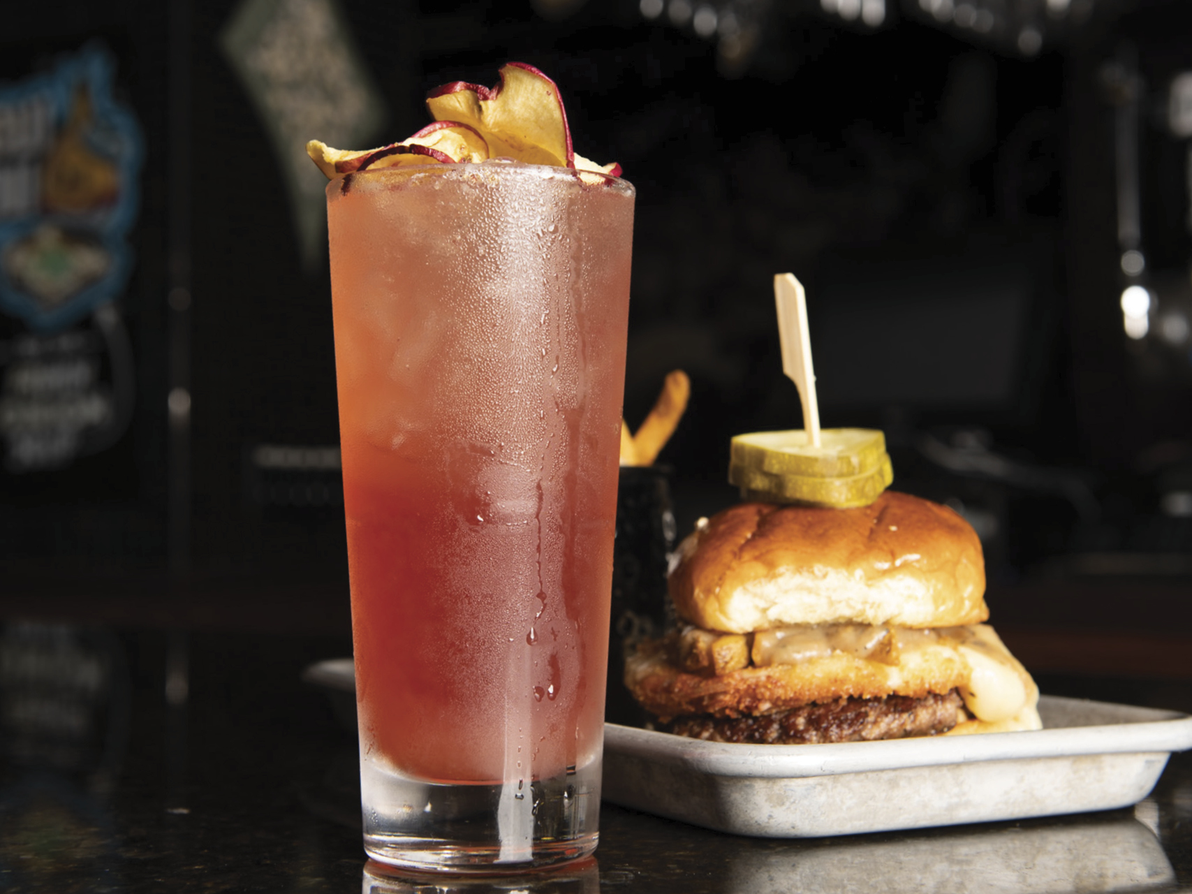 Bar Louie's featured Cocktail for this program is the Bourbon Apple Highball: Maker's Mark Bourbon, Pama Liqueur, apple, cranberry, lemon, Fever Tree Ginger Beer, topped with apple chips.