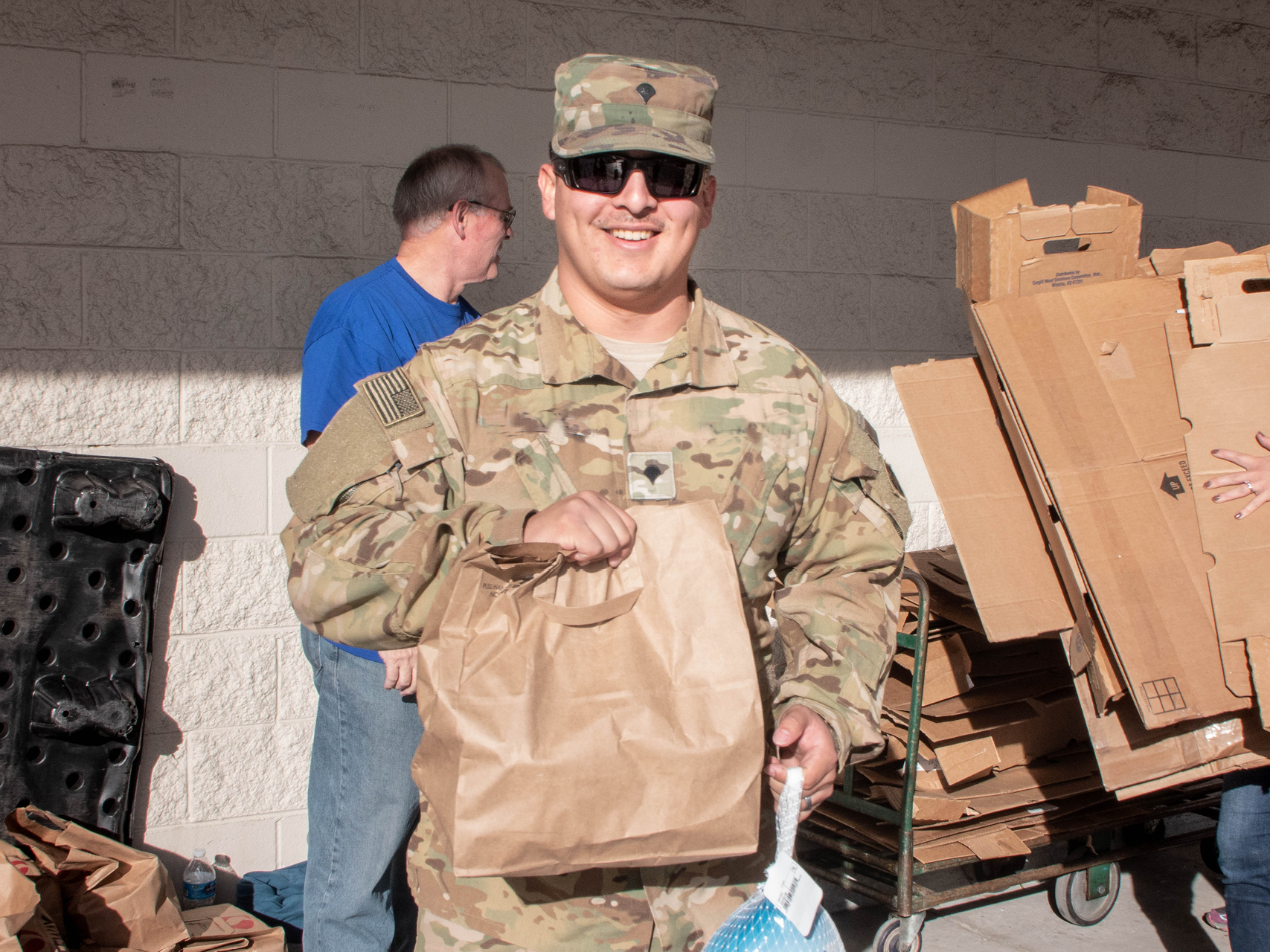 Patron picking up a meal from Operation Homefront.