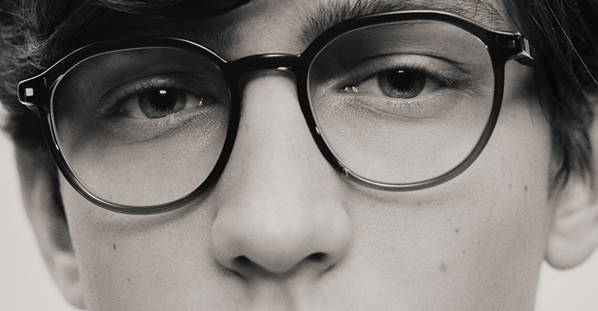 Close up of young man wearing glasses