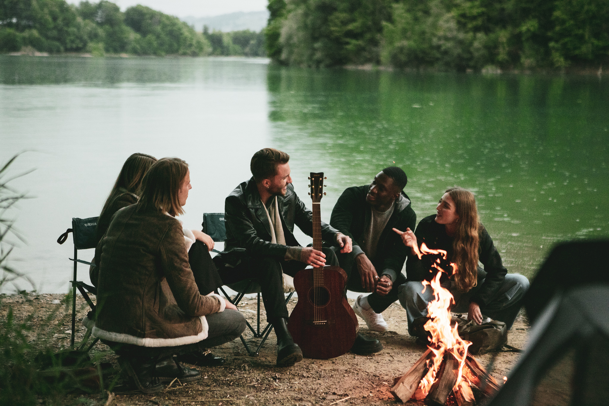 Group sitting by lake