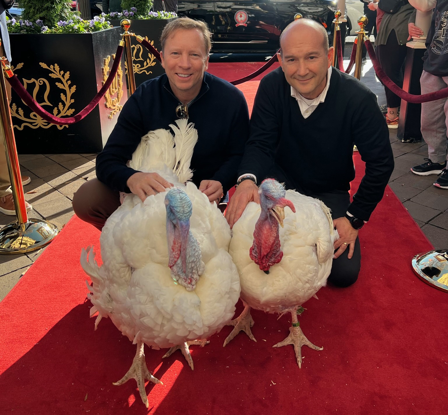 NTF Chairman Steve Lykken and Jose Rojas from Jennie-O Turkey Store escort Liberty and Bell down the red carpet at the Willard InterContinental.