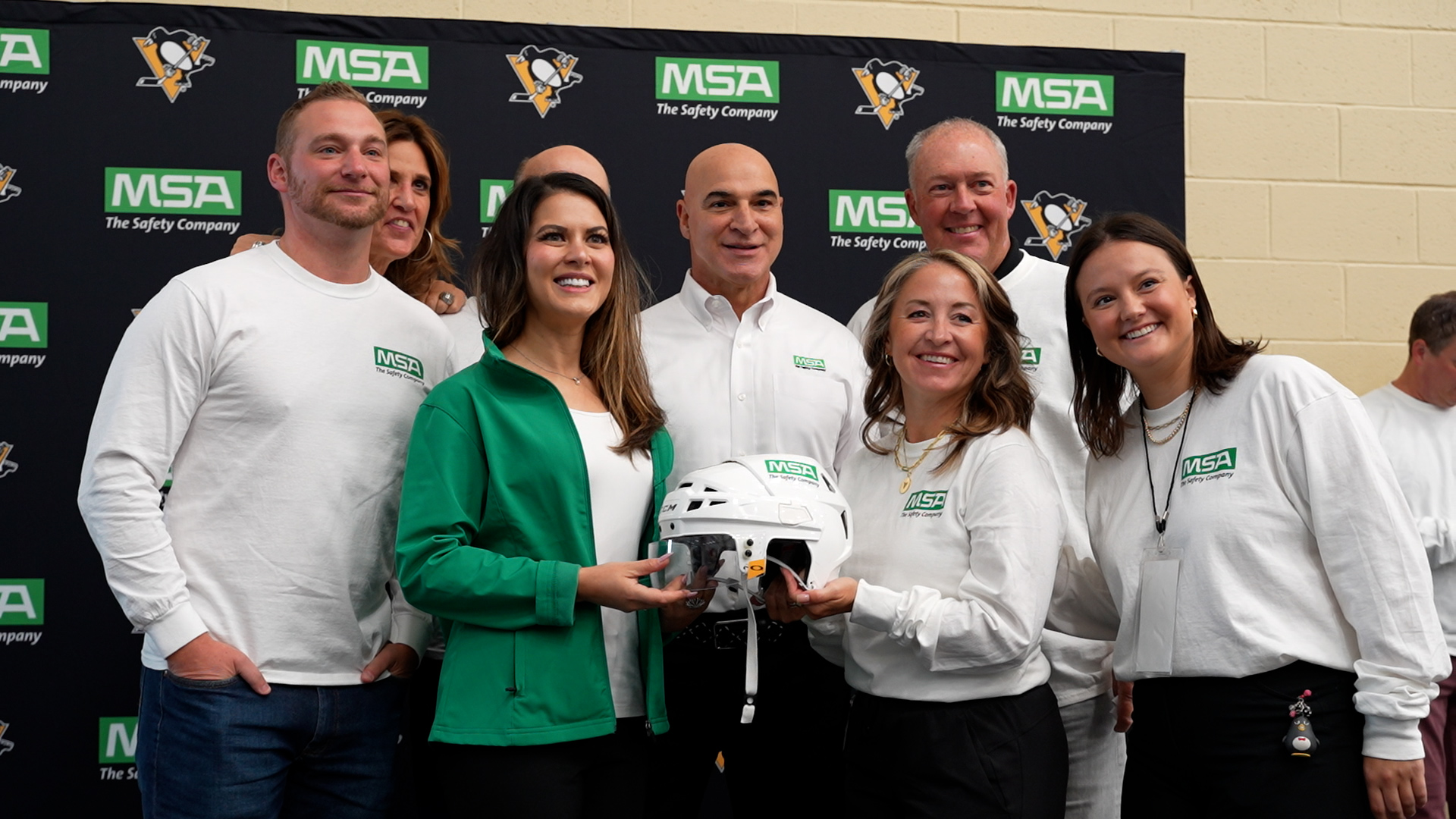 Representatives of MSA Safety and the Pittsburgh Penguins celebrate the announcement of the new away game helmet partnership.
