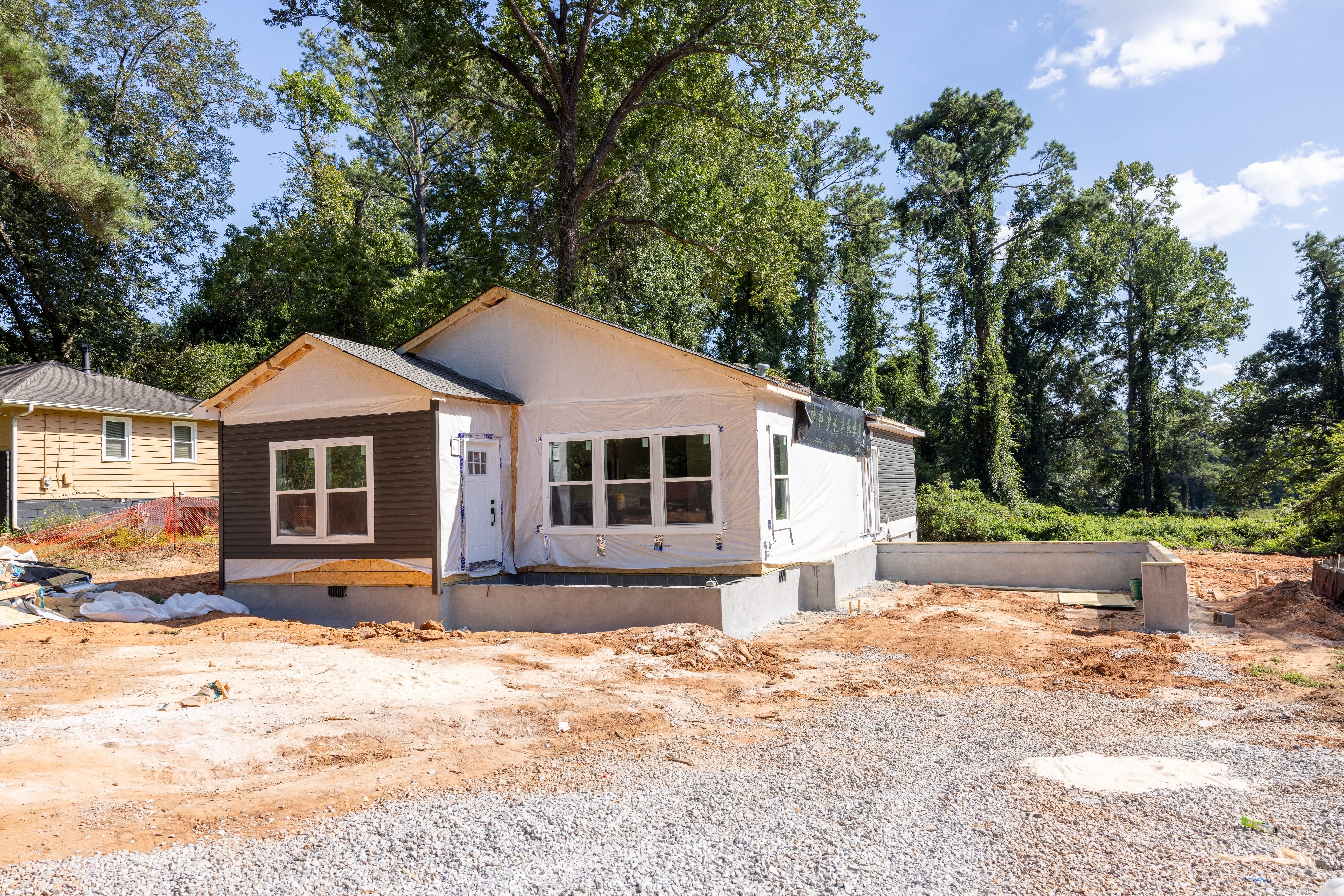 CrossMod homes are built to HUD code and blend the best of off-site and site-built construction. Once on-site, elements like the porch and garage are built.