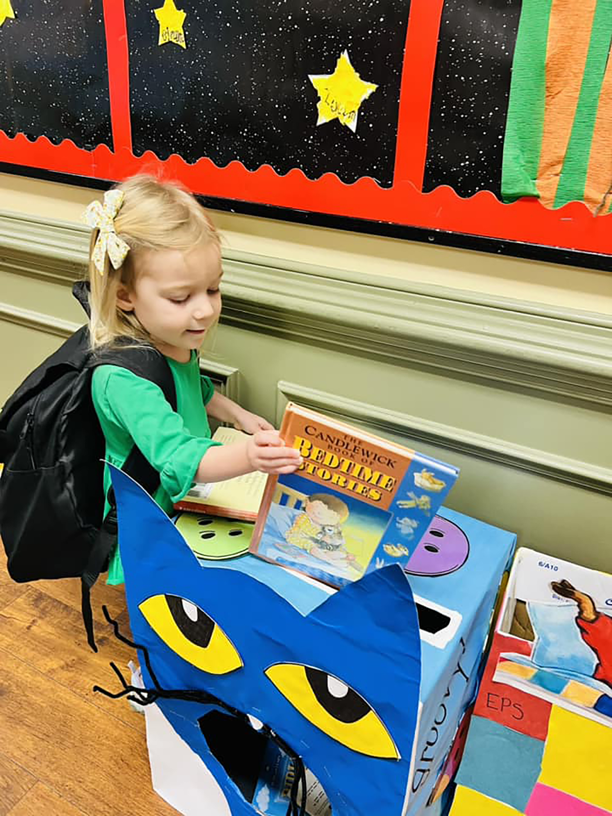 A student from Primrose School of Meadowbrook (Hoover, AL) adds to the school’s growing collection of books for its Og’s Bountiful Book Drive.