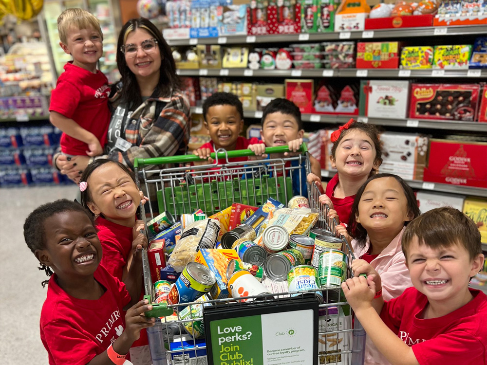 Students from Primrose School at Johns Creek (Suwanee, GA) purchase nonperishable food items to benefit the annual Caring and Giving Food Drive. 
