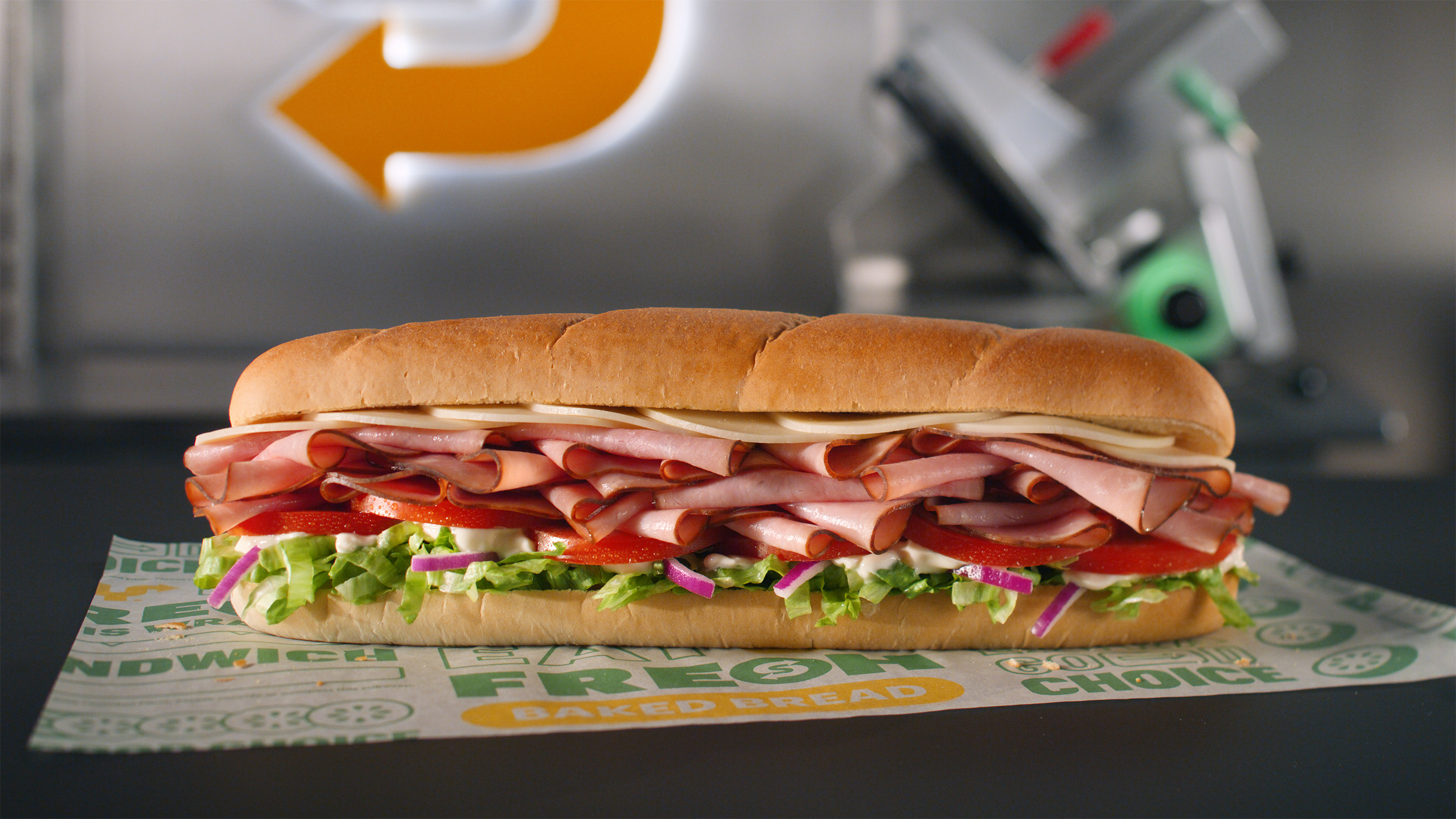 The Grand Slam Ham (#99) comes with 33% more meat than traditional subs, with freshly sliced ham and double provolone cheese, stacked with lettuce, tomato, red onions on Artisan Italian bread, drizzled with mayonnaise.