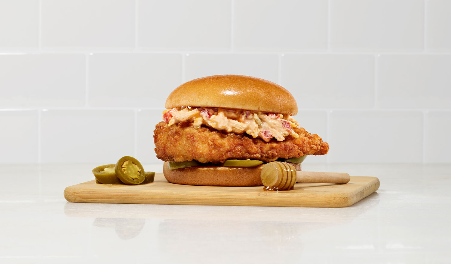 The new sandwich features an original Chick-fil-A filet, custom-made creamy pimento cheese, mild pickled jalapeños and is served on a toasted bun drizzled with sweet honey.