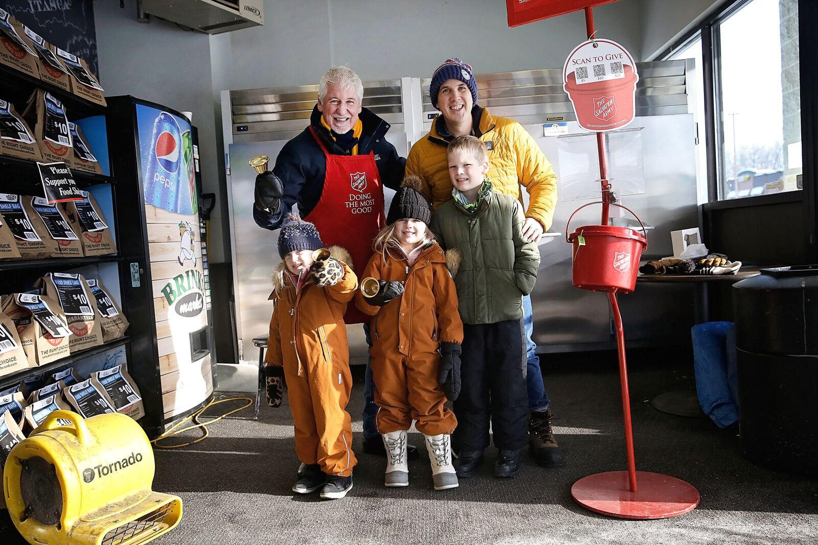 Salvation Army volunteers ringing bells at a Red Kettle