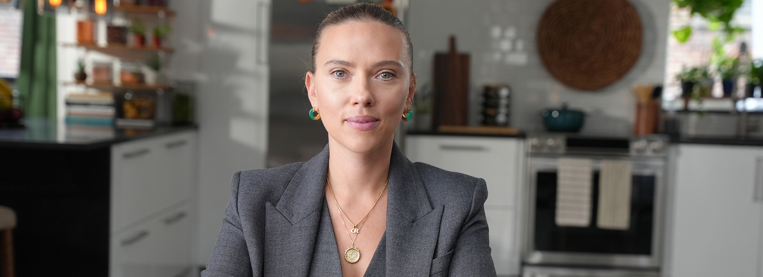 Scarlett Johansson sits at a table for the Feeding America PSA