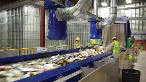 Recycling materials being dumped into a large conveyor belt
