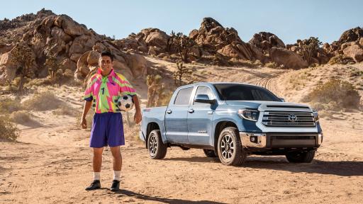 Campos standing in front of a Tundra Toyota truck in the desert.