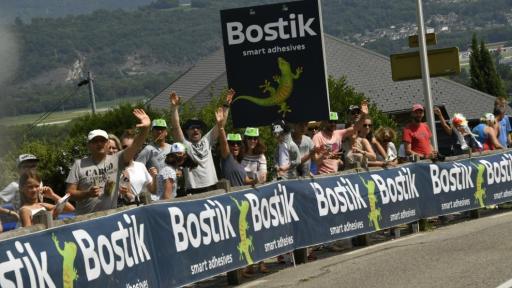 Fans enthousiastes le long de la route brandissant partout des banderoles Bostik