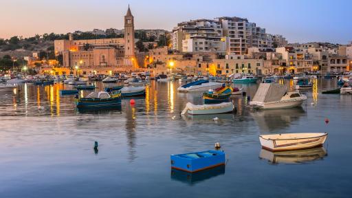 Image of fisherman & passenger boats at Marsaskala Bay, Malta, in the evening.