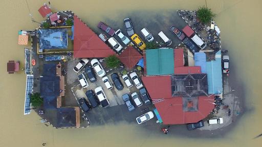 Top down image of vehicles surrounded by floodwater.