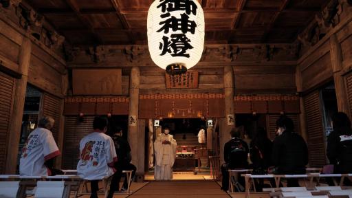 Image At Keta Shrine, visitors pray for the safety of their trip and receive power by offering a tama-kushi, a traditional ritual.