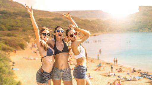 Image of three women enjoying the sandy beaches of Malta