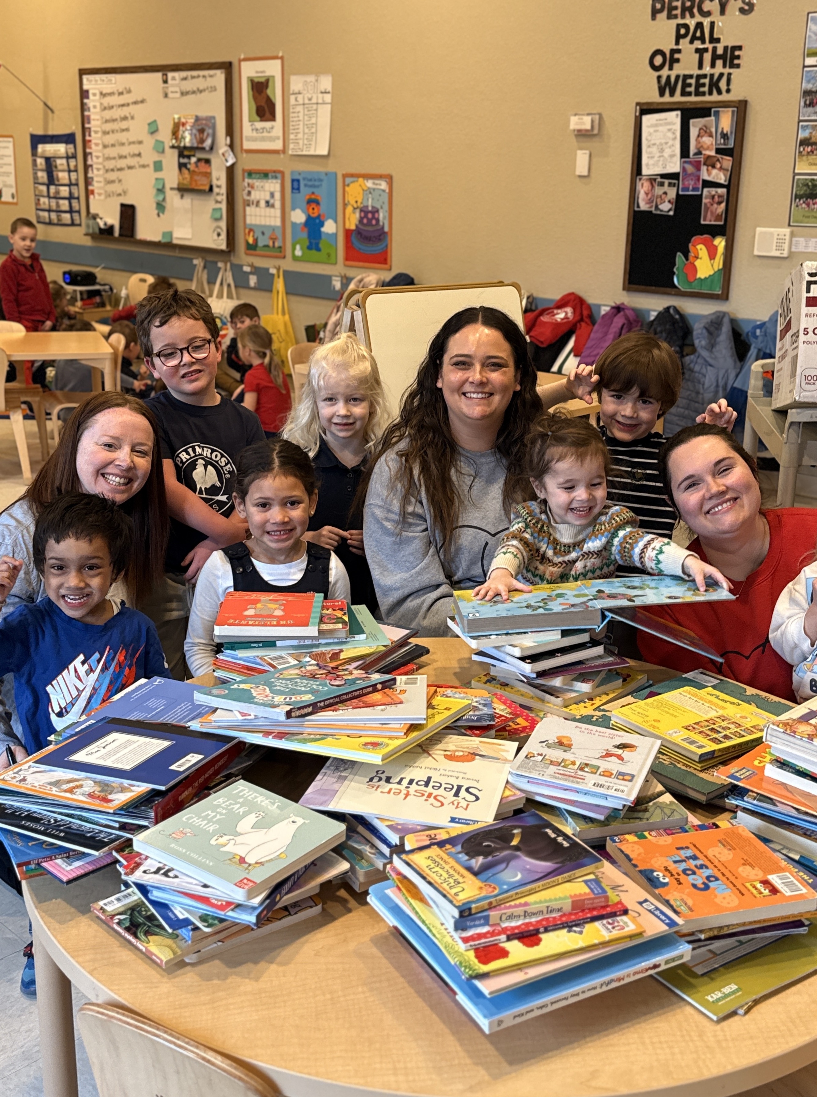 With stacks of books ready to donate, children and teachers from Primrose School of Edina in Minneapolis, Minn., help bring the joy of reading to more families through Og’s Bountiful Book Drive.