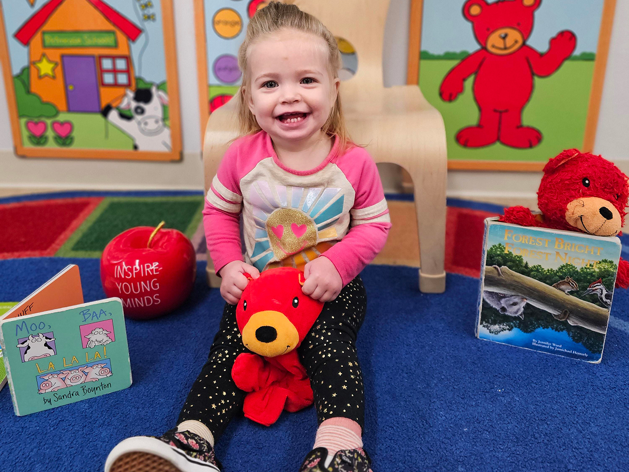 A young learner from Primrose School of Littleton in Denver, Colo., enjoys story time during Og’s Bountiful Book Drive.